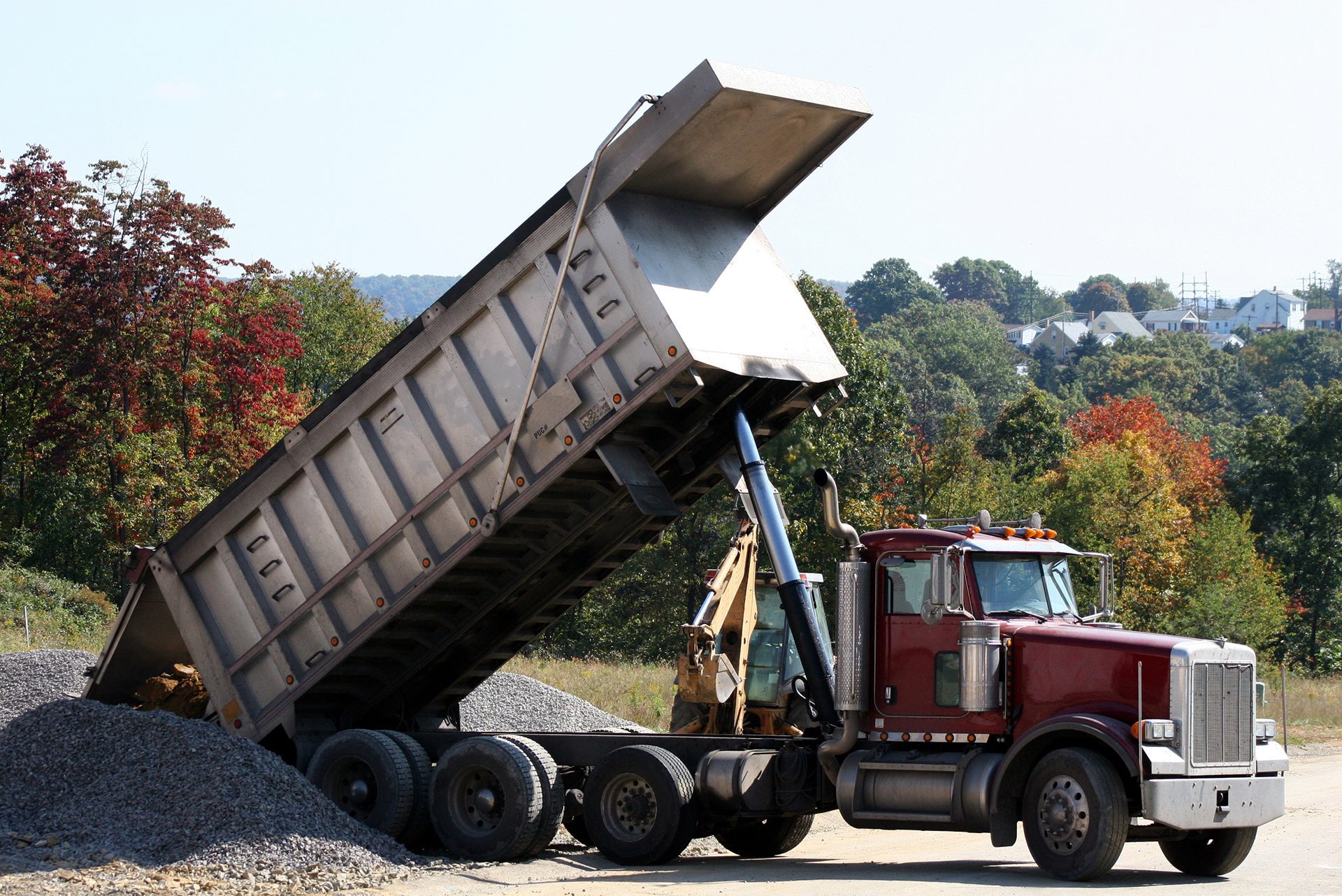 dump truck pouring some aggregate materials into a pile